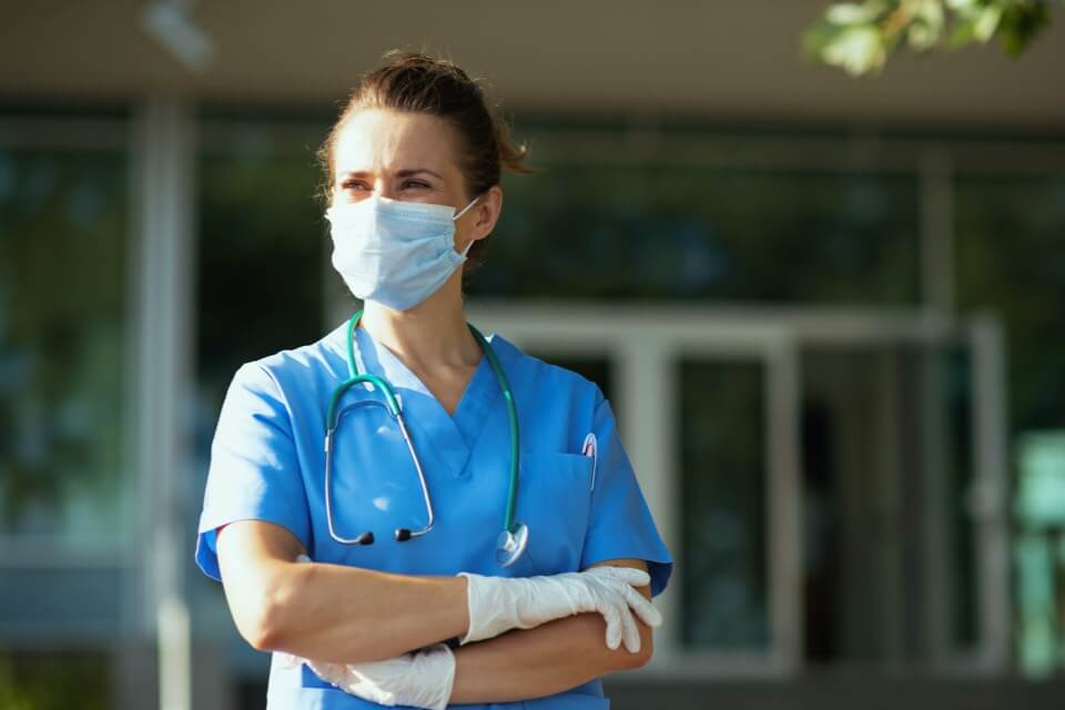 Female doctor standing outside wearing facemask