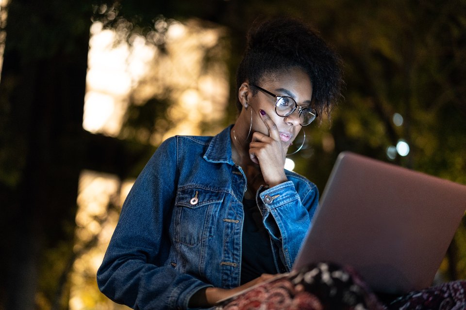 Female student looking at laptop screen with concentration
