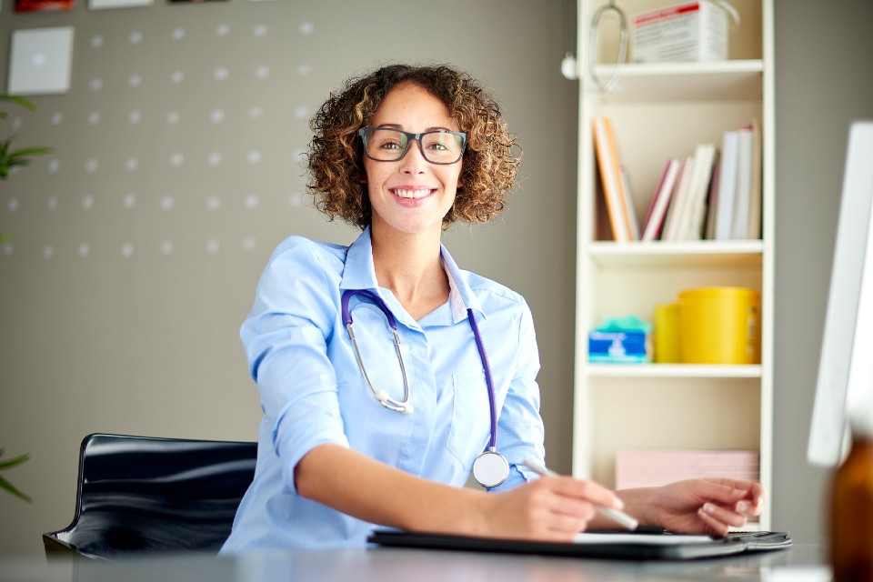 Female medical professional sitting at desk in office