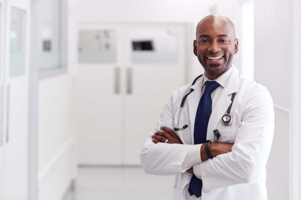 Male medical professional standing in corridor