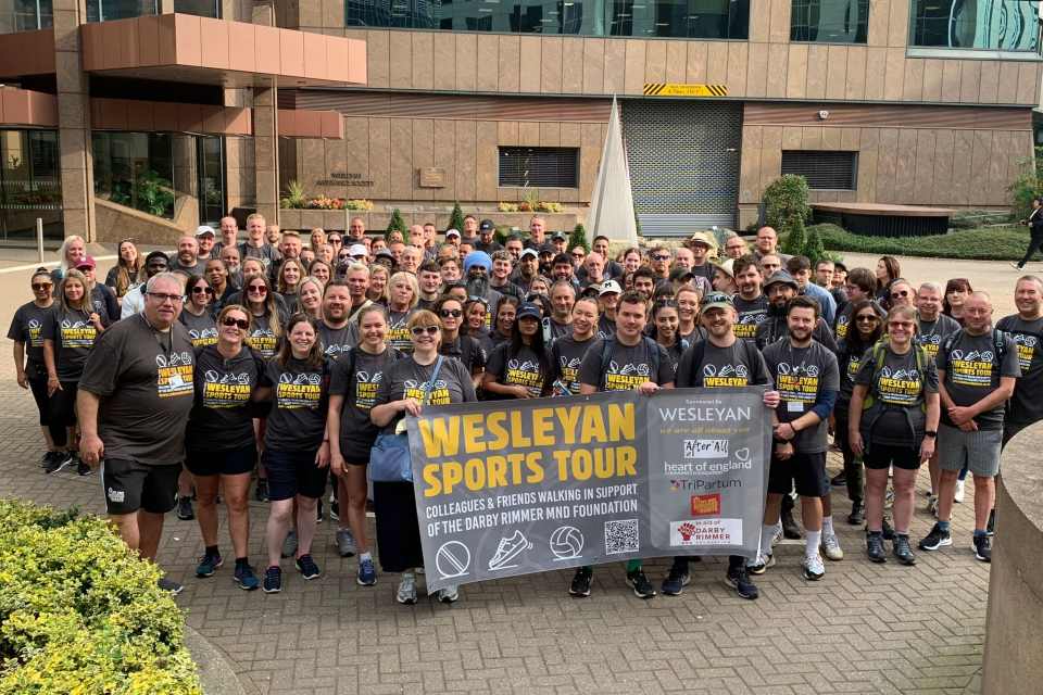 Group of Wesleyan employees standing outside Wesleyan building