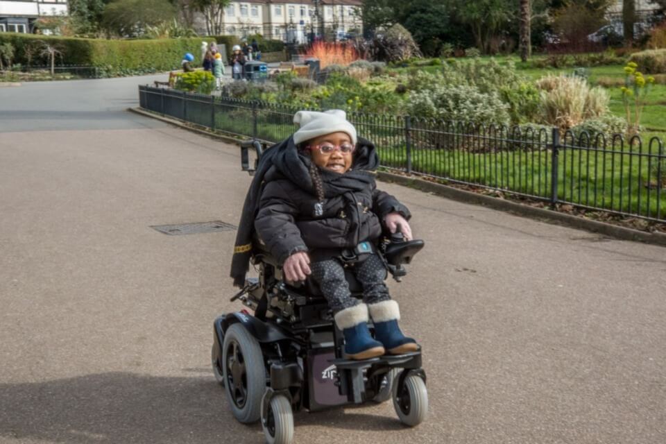 Young child in wheelchair outside