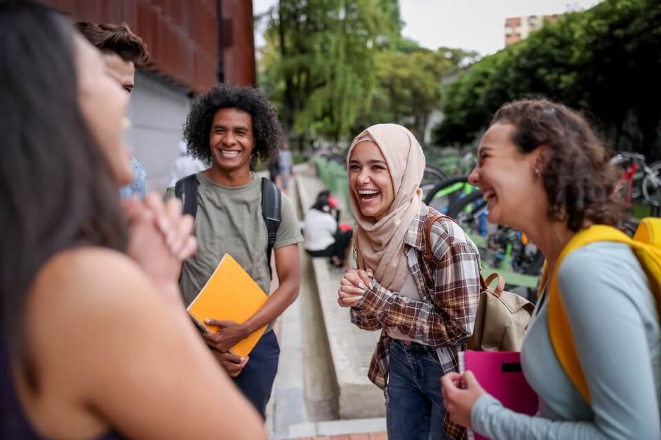 Group of students laughing together outside