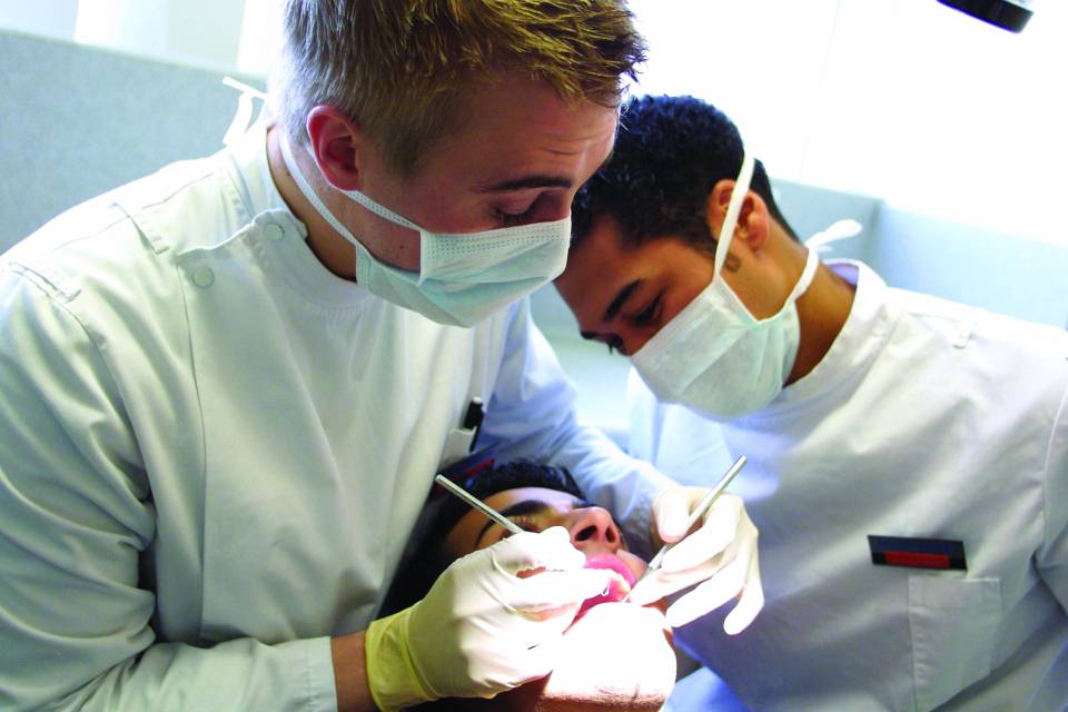 Two dentists with patient