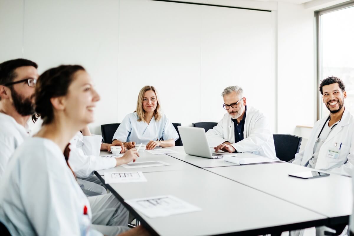billboard-group-medical-professionals-sat-at-table Group of medical professionals sat at a table