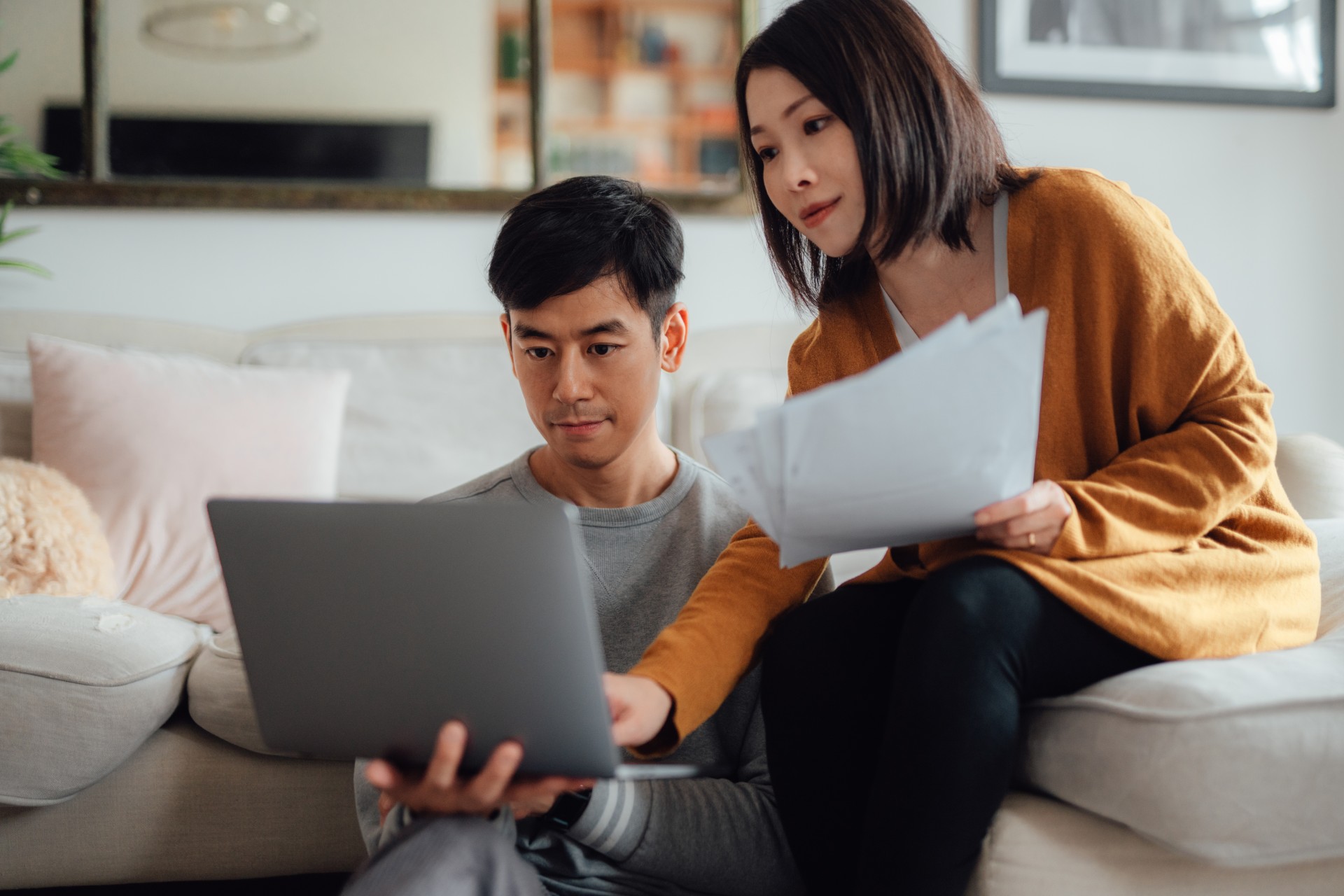 Couple on sofa using laptop Couple on sofa using laptop