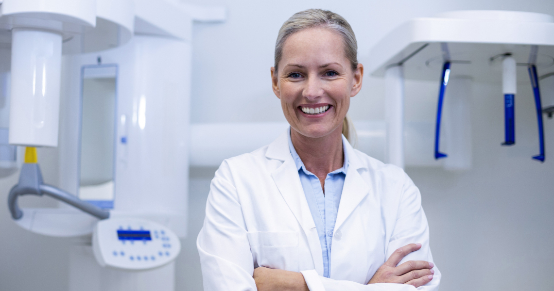Doctor in medical room wearing a white coat Doctor in medical room wearing a white coat