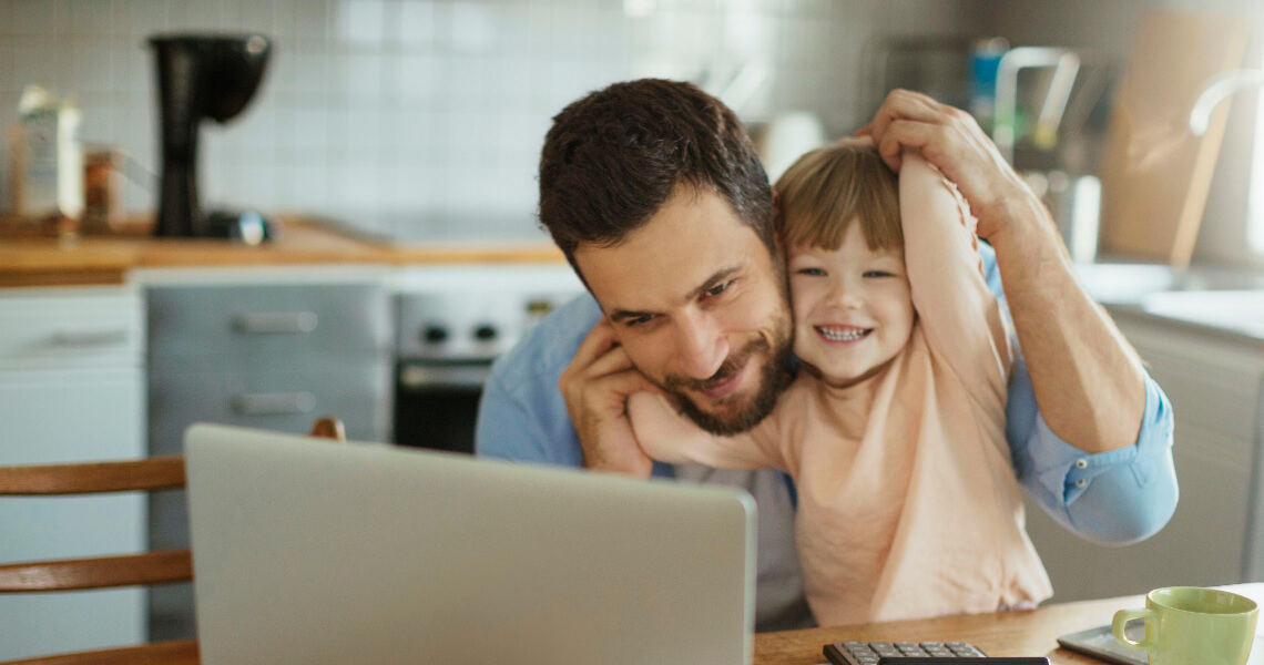 Father and son in kitchen on laptop video call
