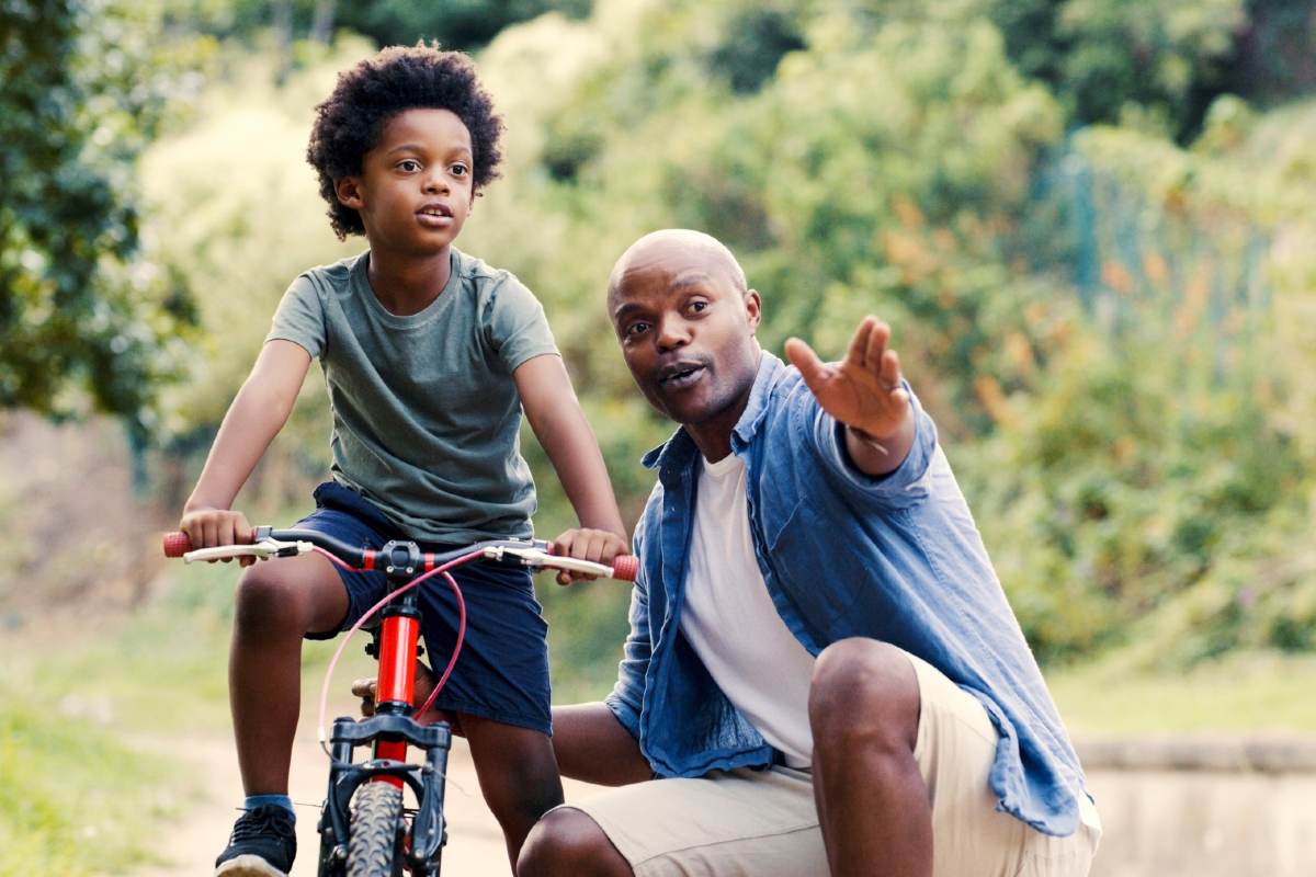 Father teaching child how to ride bike Father teaching child how to ride bike