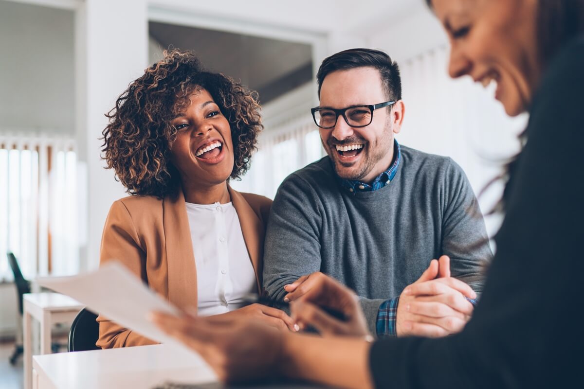 Happy couple getting financial advice Happy couple getting financial advice