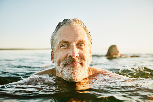 Man swimming in sea Image of man swimming in sea