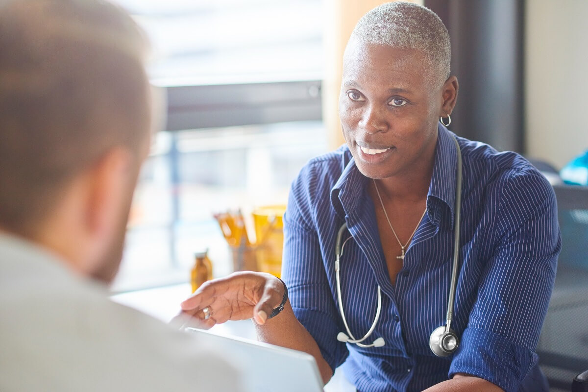 Mature female medical professional with patient Mature female medical professional with patient
