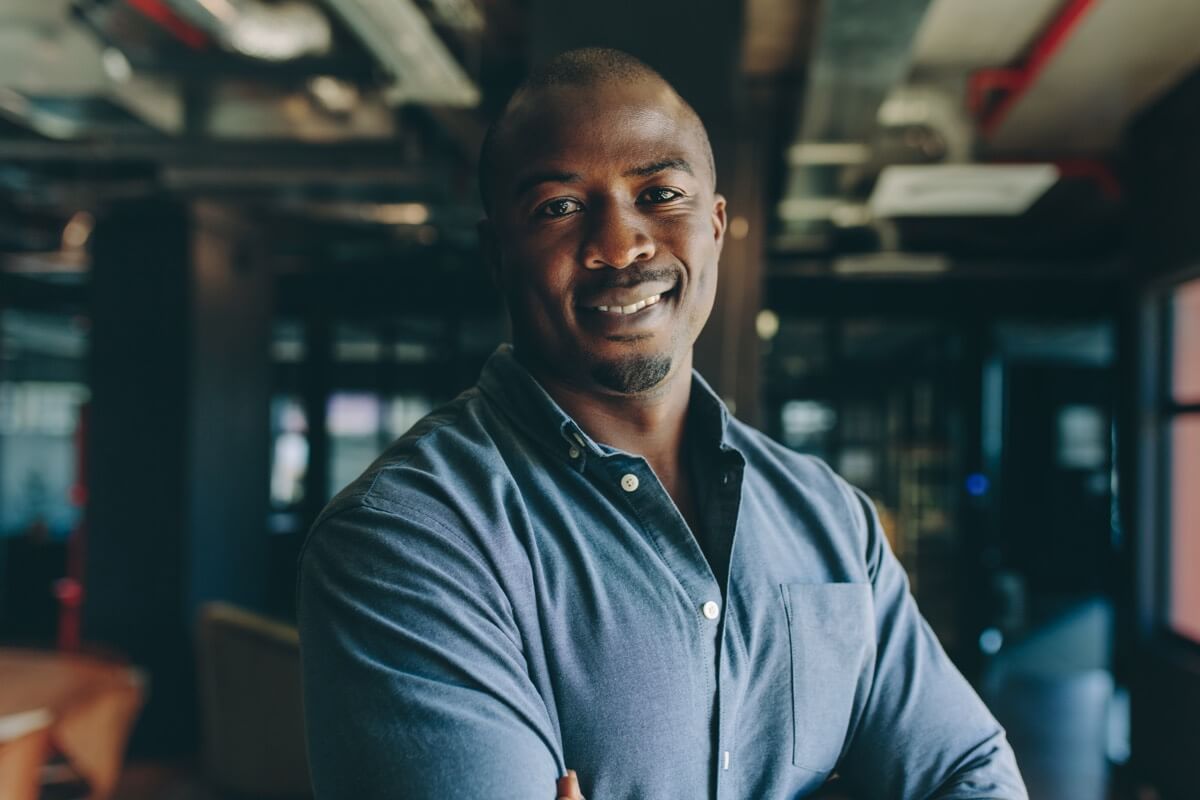 Professional man smiling in modern office Professional man smiling in modern office