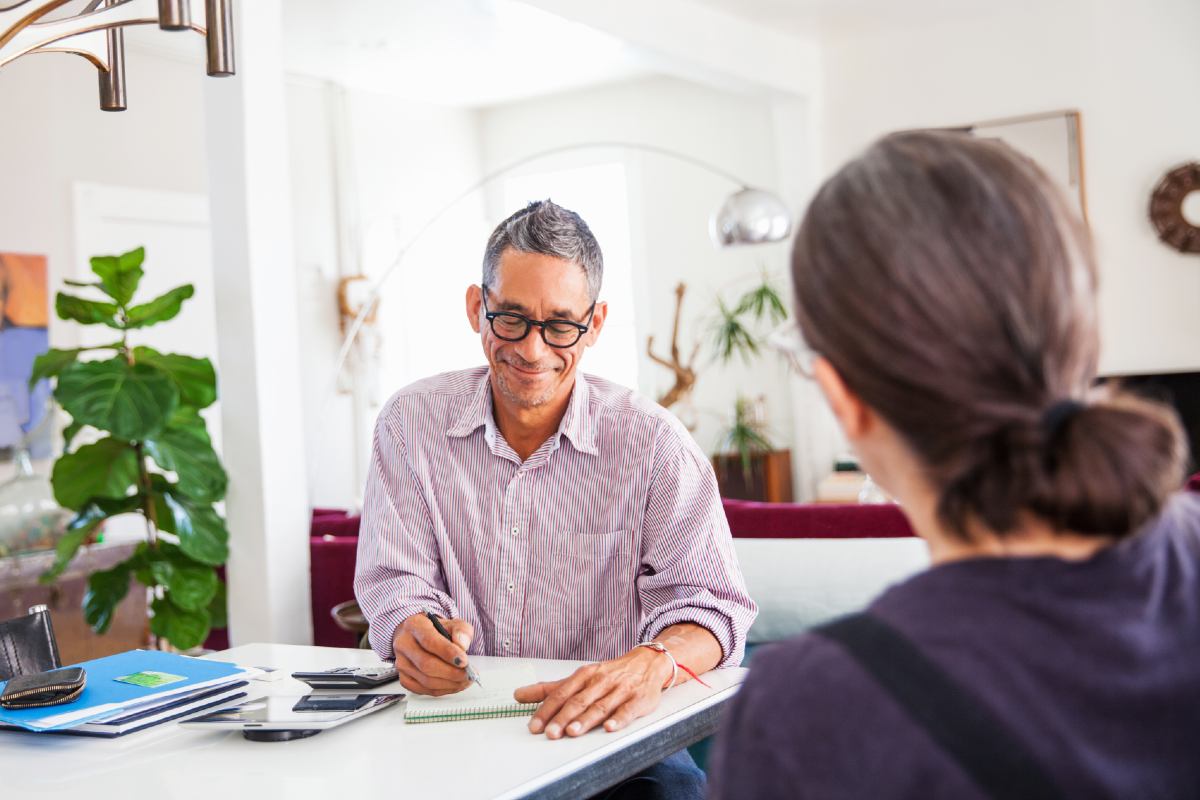 Professional man talking with woman in home Professional man talking with woman in home