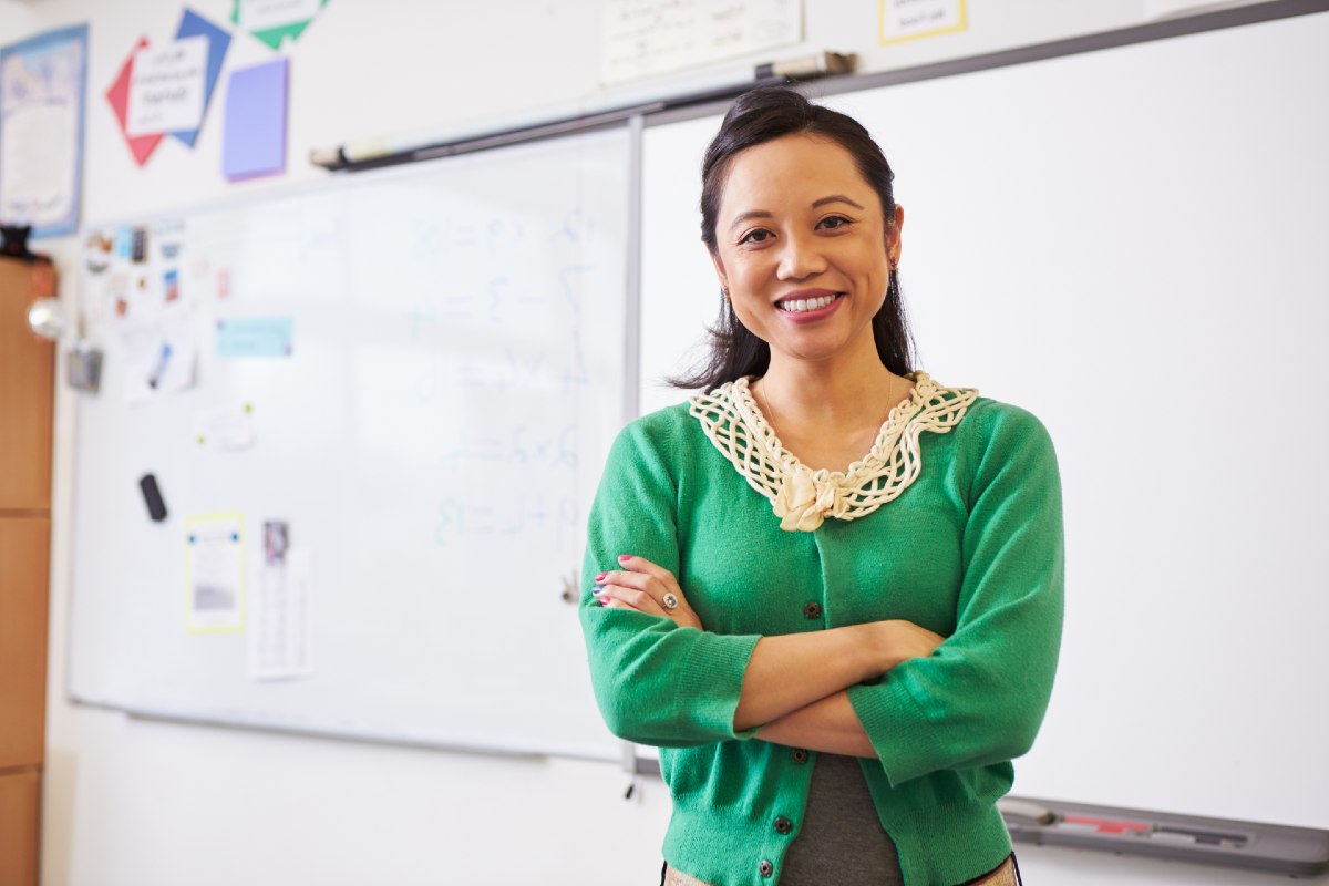 Female teacher standing in front of whiteboard