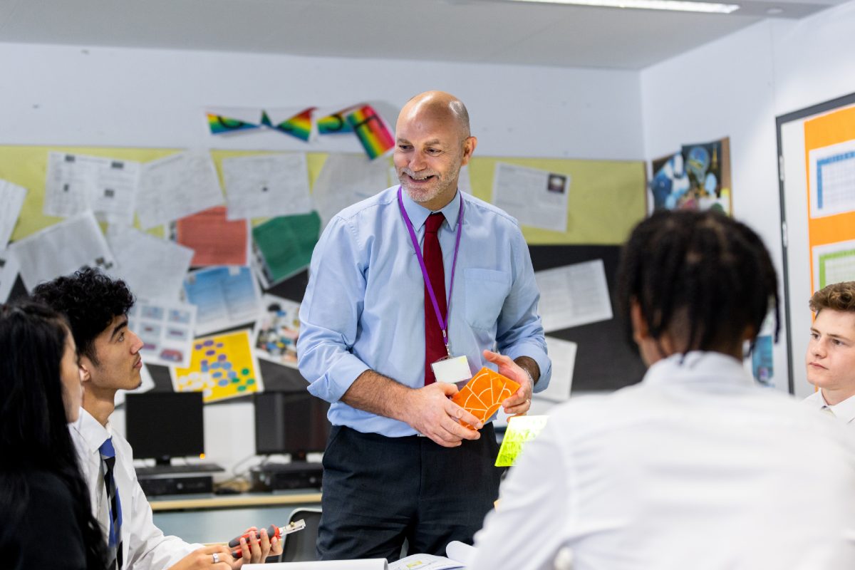 Male teacher in classroom with students