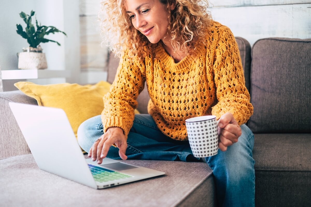 Woman on sofa browsing internet Woman on sofa browsing internet