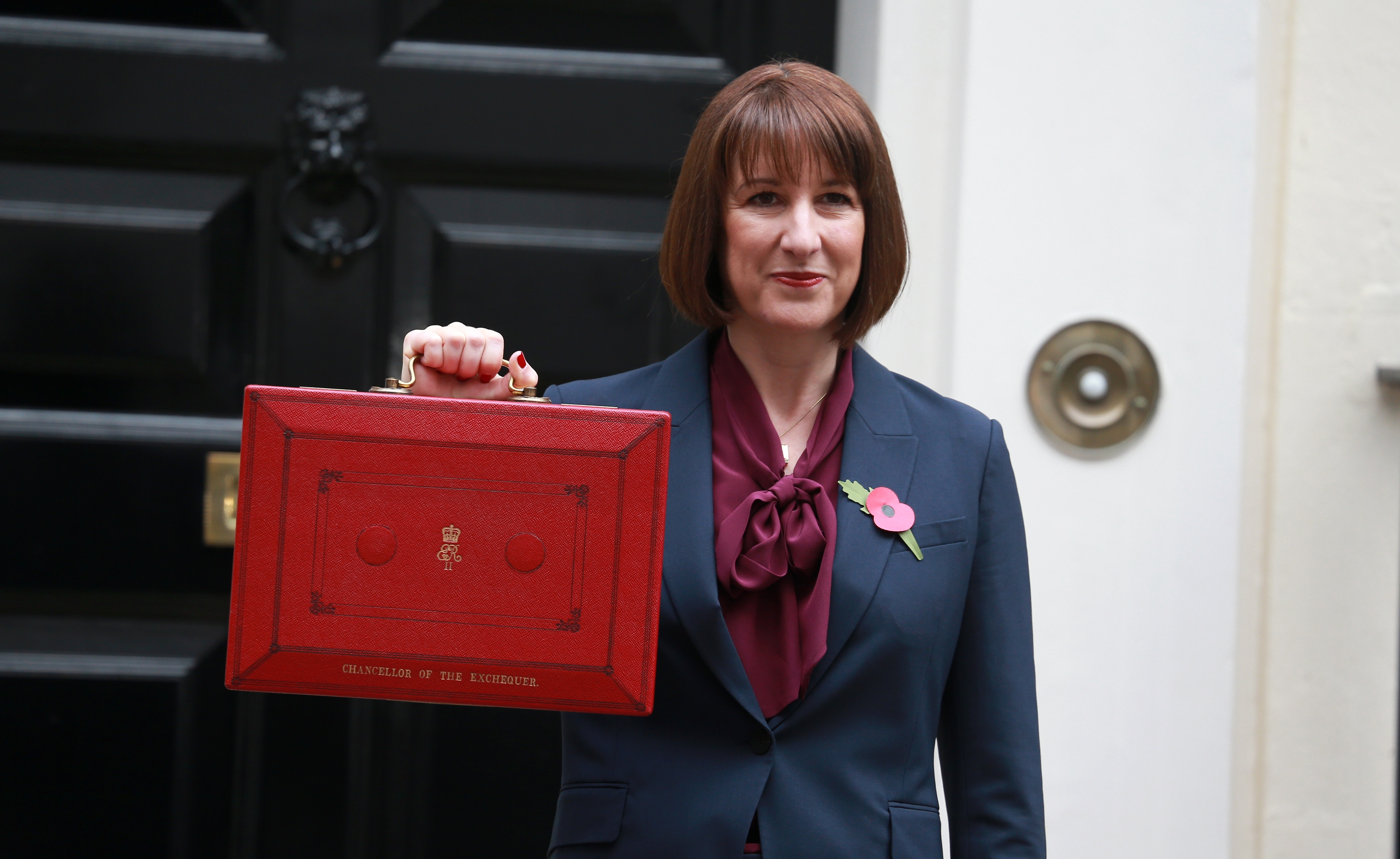 autumn-budget-blog Rachel Reeves holding up the red briefcase outside Downing Street