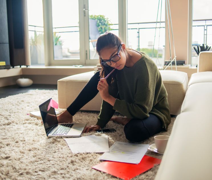 Female looking at papers in her home Female looking at papers in her home