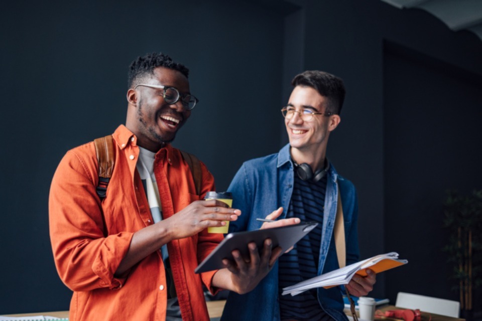 Two male students talking and smiling