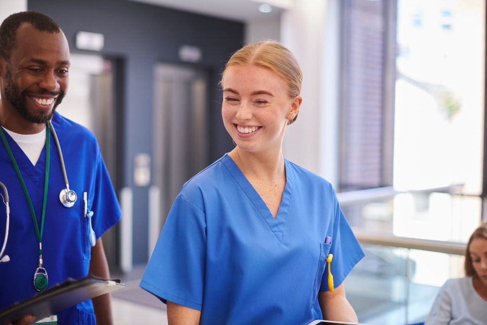 Male and female medical students wearing scrubs