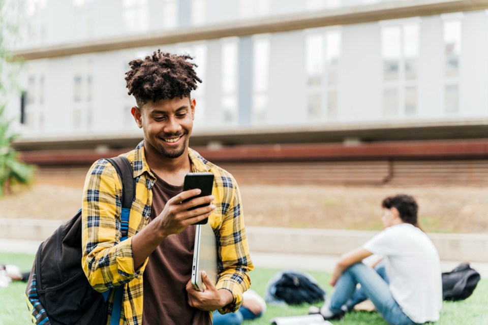 Student using phone outside