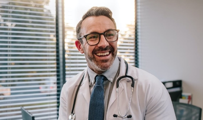 Mature male doctor with glasses in office
