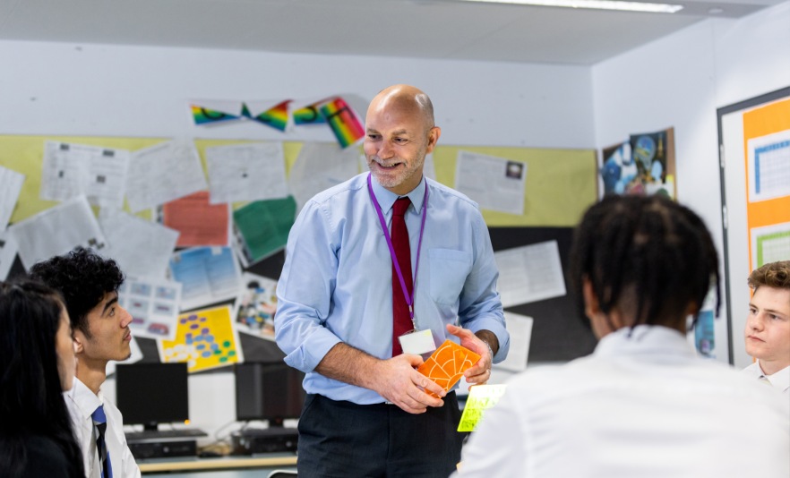Male teacher in classroom with students