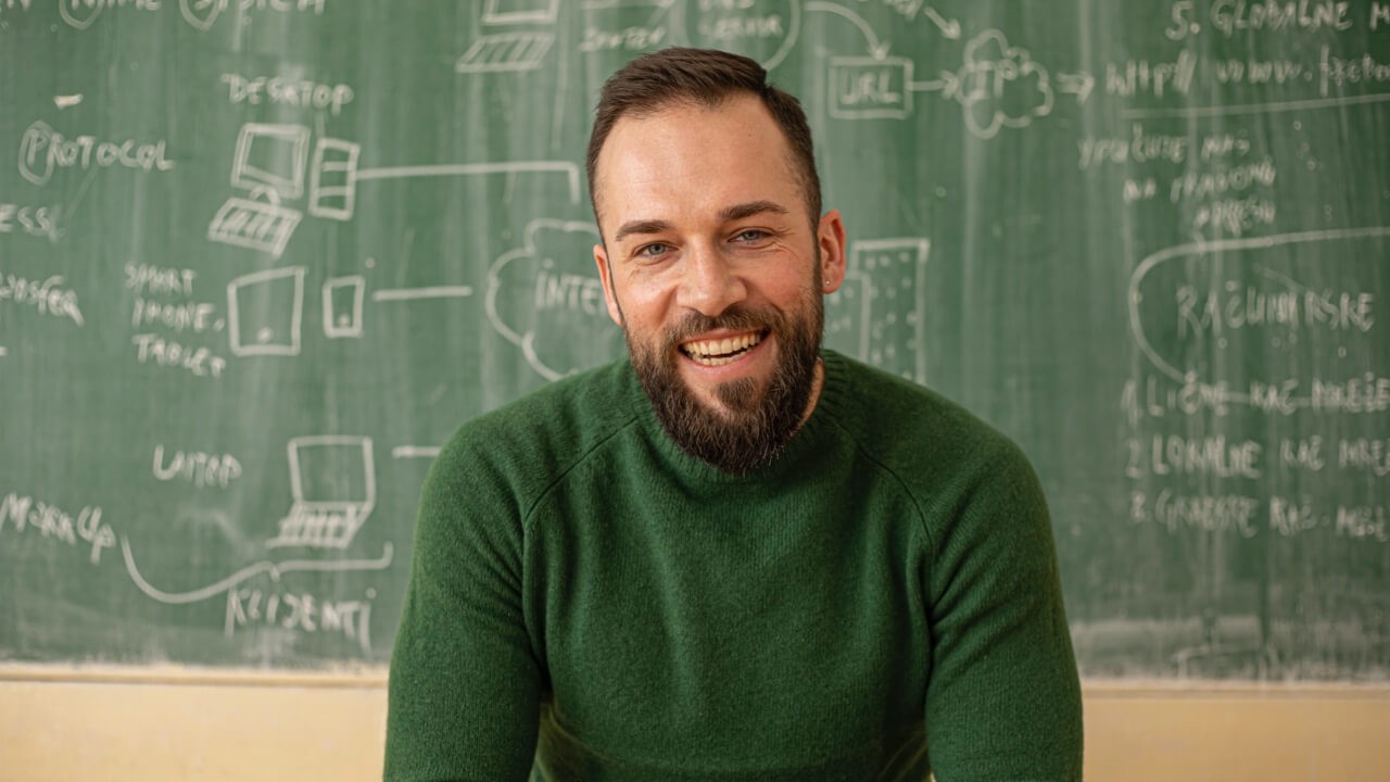 Male teacher in front of chalkboard