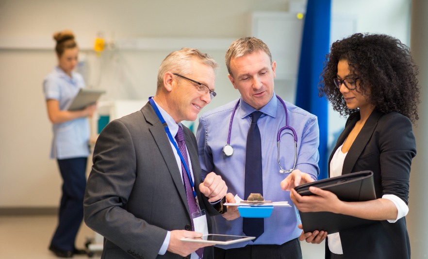 Medical professionals standing together looking at paperwork