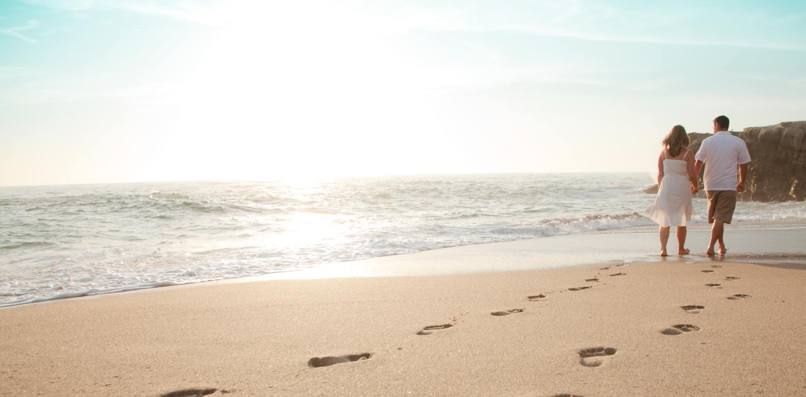 Couple walking on the beach in the distance