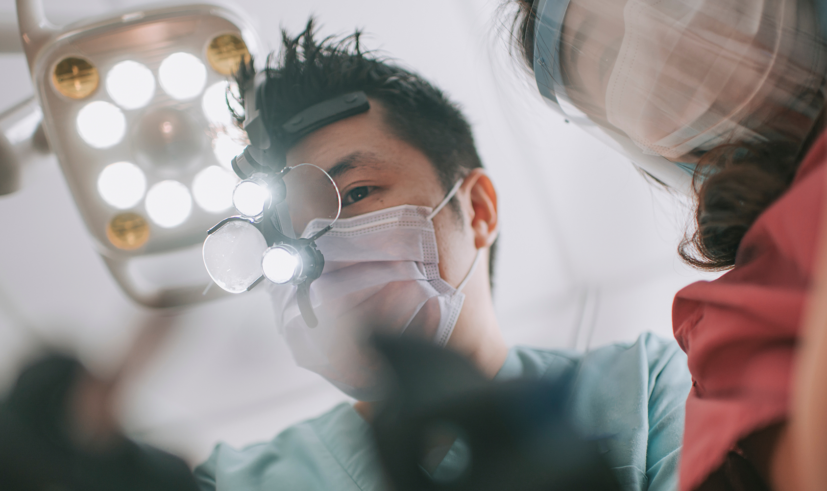 Male dentist mid-surgery