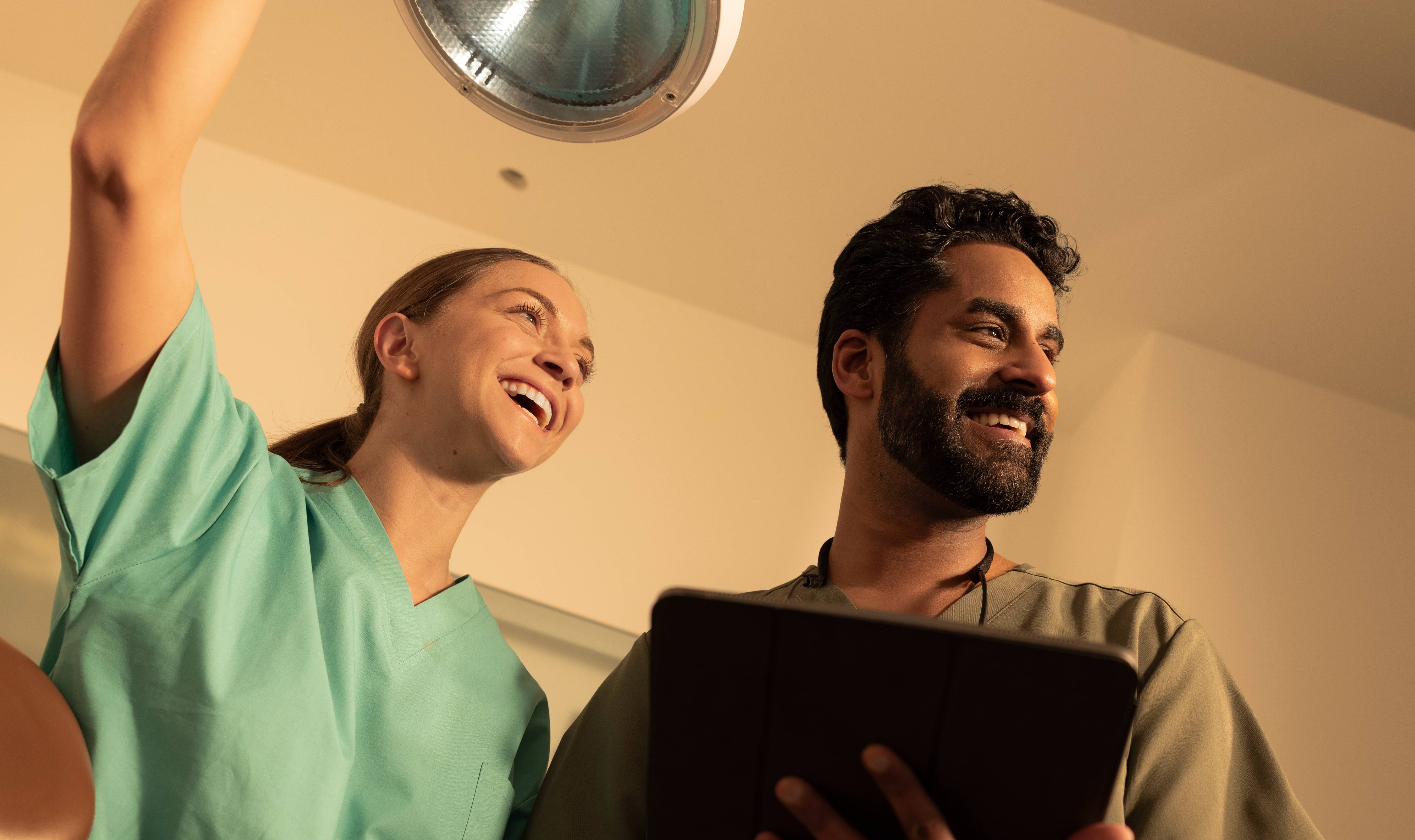 Male and female dentists smiling