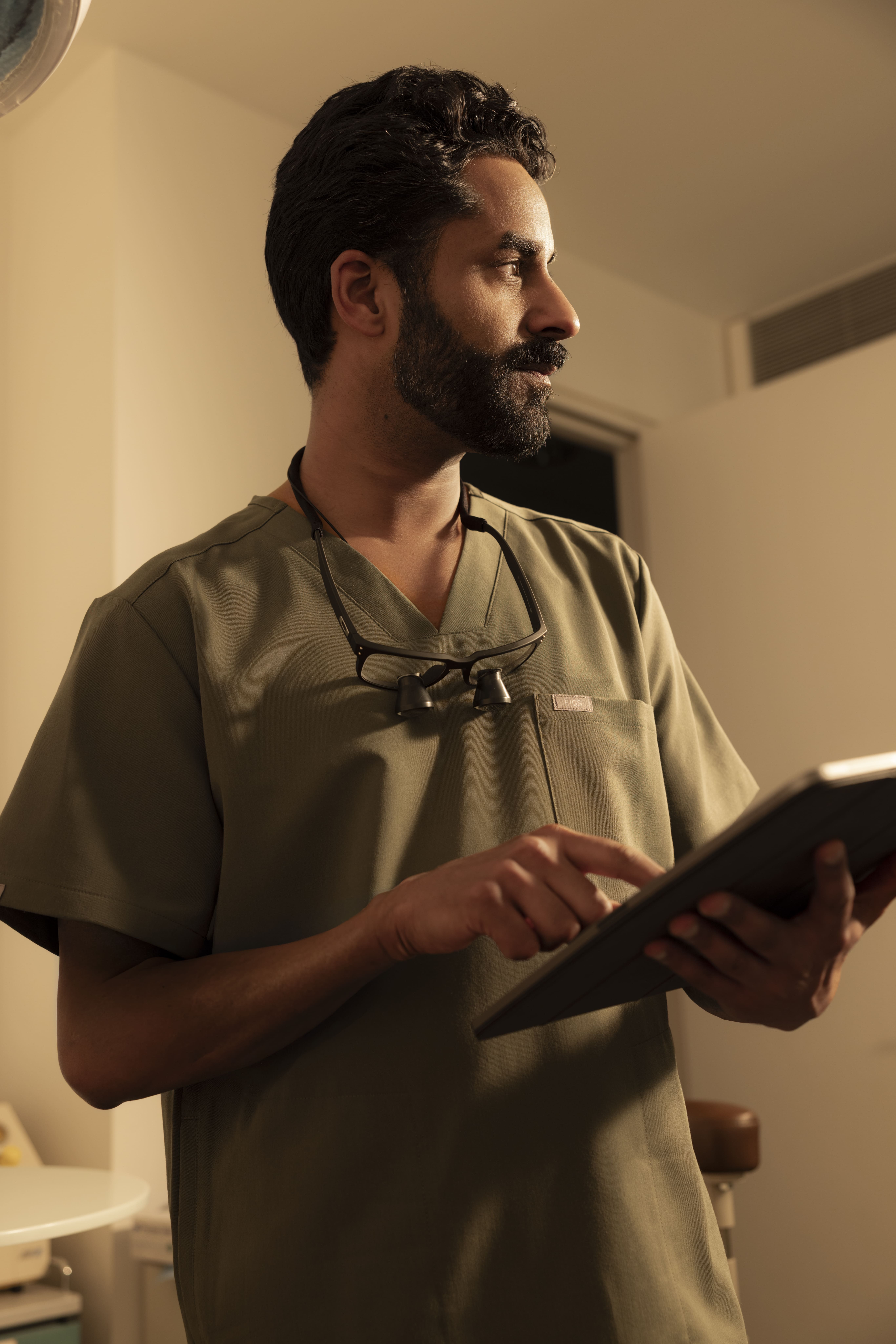 Male dentist with clipboard