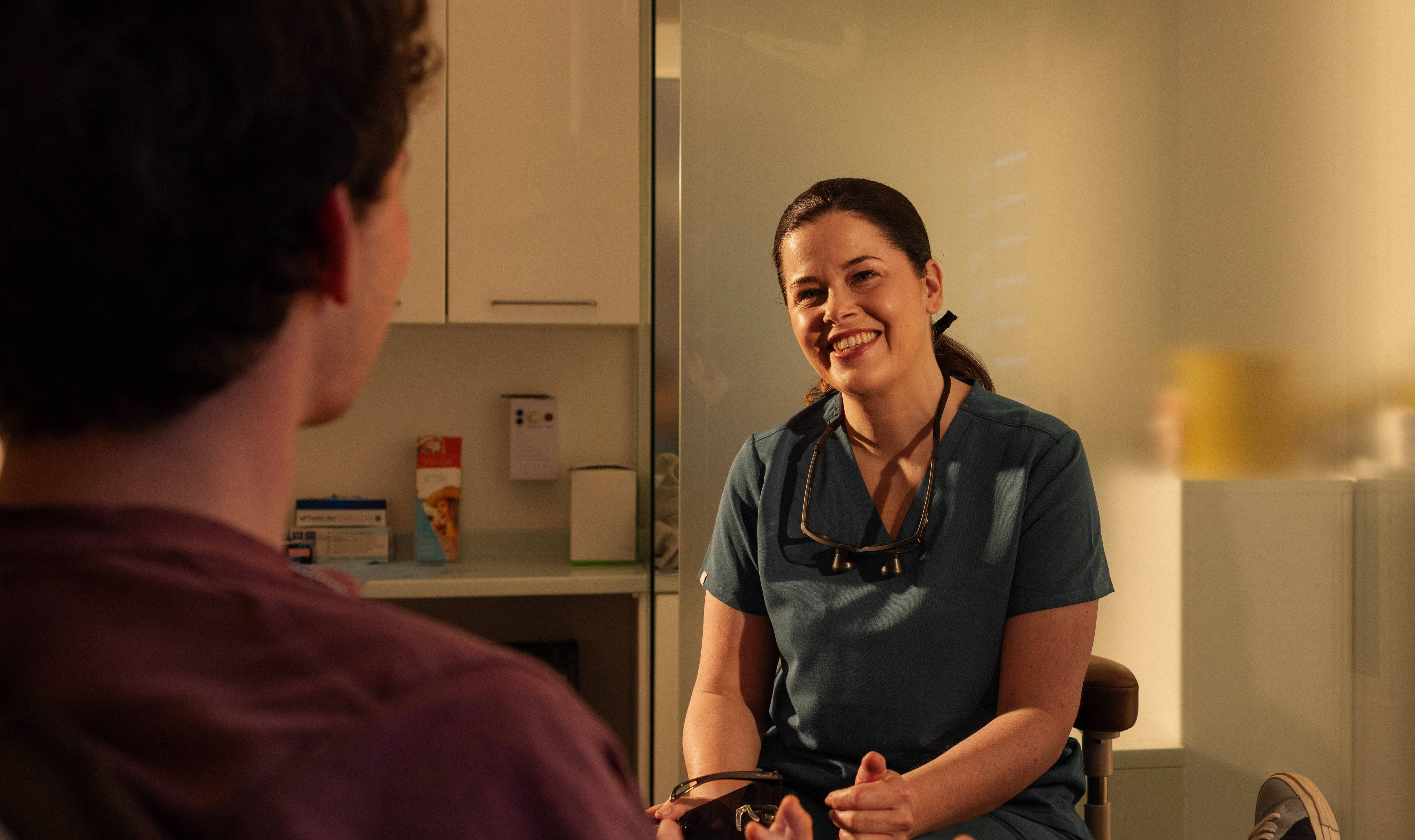 Female dentist smiling at patient
