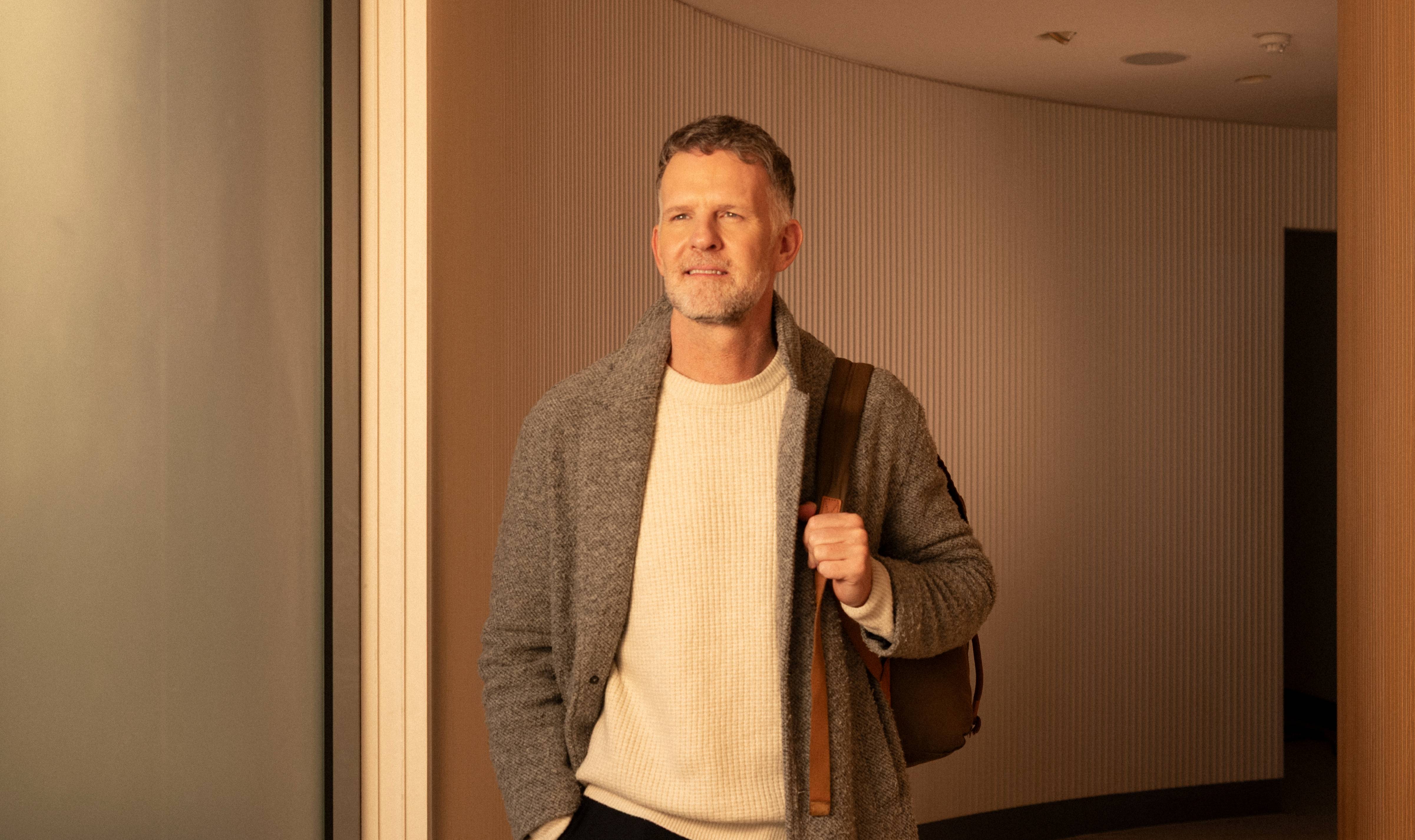 Male dentist leaves shift in plain clothes