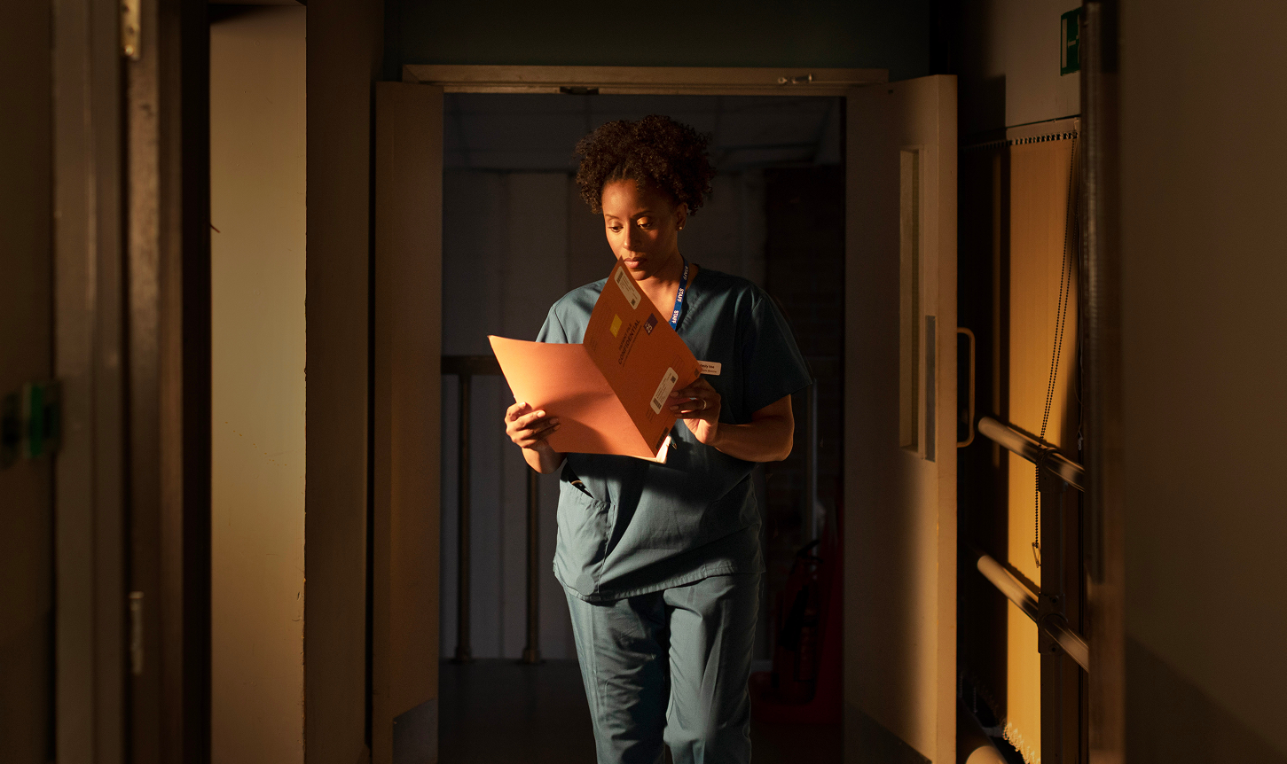 Female doctor reading folder