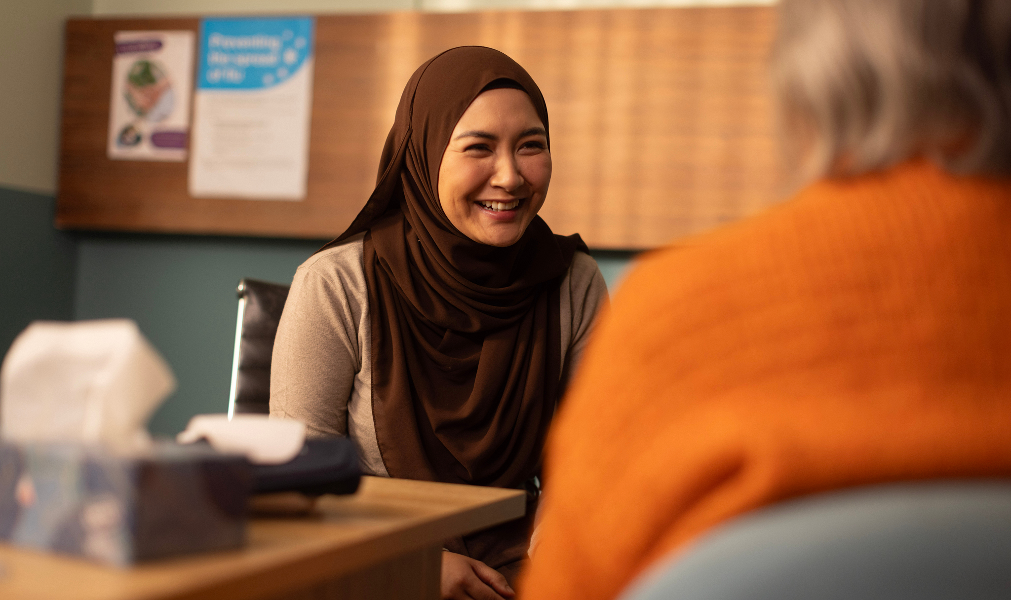 Woman smiles whilst in discussion