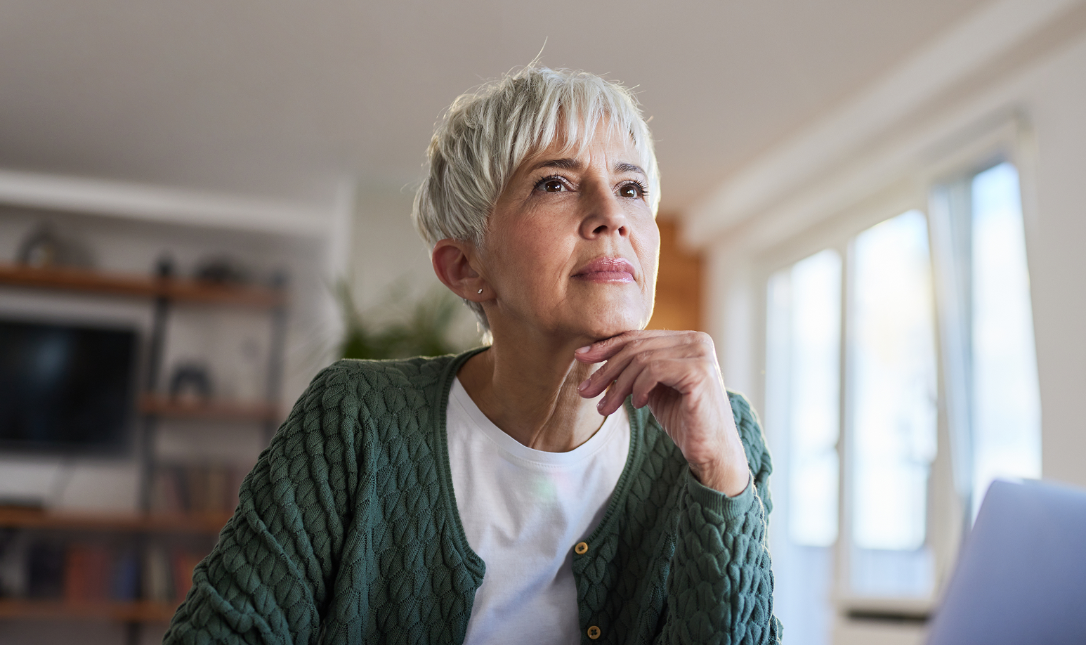 Woman on laptop looking pensive